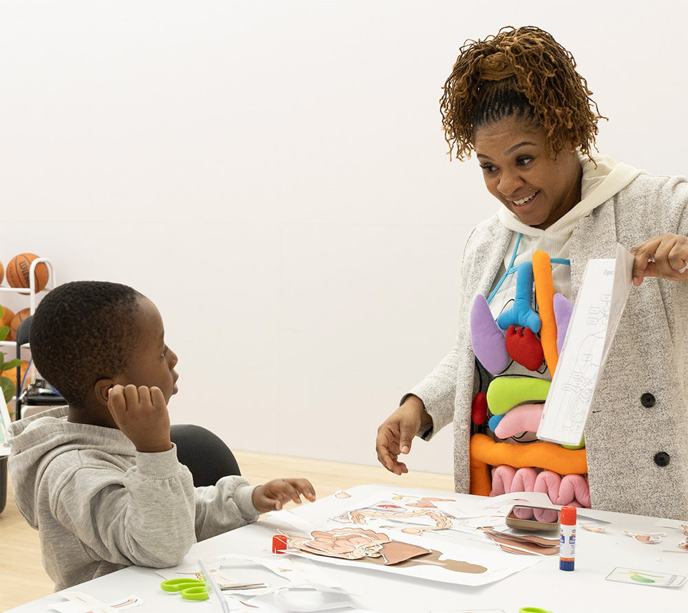 A child educator showing a diagram to a child.